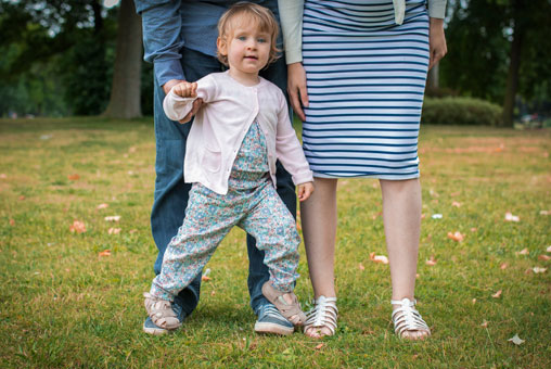 Séance Laetitia, Stéphane et Maëla, photo extérieur Bois de Vincennes, île de Reuilly et Île de Bercy, Maela qui marche sur les pieds de ses parents